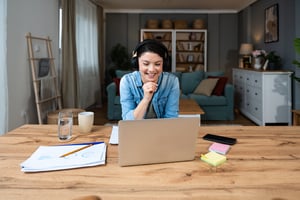 Young freelance businesswoman attending online educational class on laptop computer webcam teleconference in progress watching and listening educator expert about economy and finance. Online business iStock-2196532852