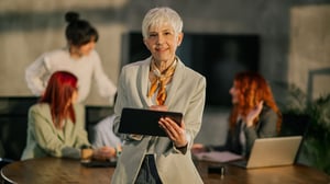 businesswoman-at-boardroom-scrolling-on-tablet_1920x1080