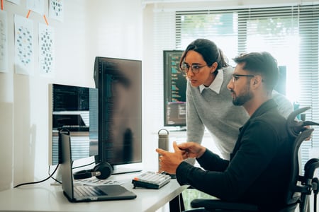 Programmers Collaborating on Software Development in a Modern Office Setting iStock-2050780380