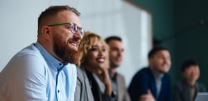 Businesspeople Listening To A Presentation In Their OfficeiStock-2150897703