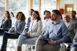 Crowd of business people having a seminar in board room iStock-1956818527