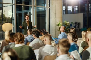 Male CEO talking to his colleagues on education event in board room iStock-2164304363