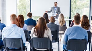 Geschäftsführer, der eine Rede auf einem Seminar im Vorstandssaal hält iStock-1340856781