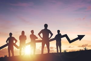 Team silhouette and up graph arrow on sunset background iStock-2149039579