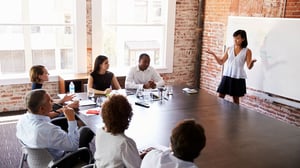 businesswoman-at-whiteboard-giving-presentation_1920x1080