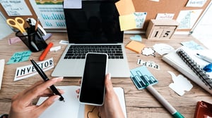 businesswoman-holding-smartphone_1920x1080