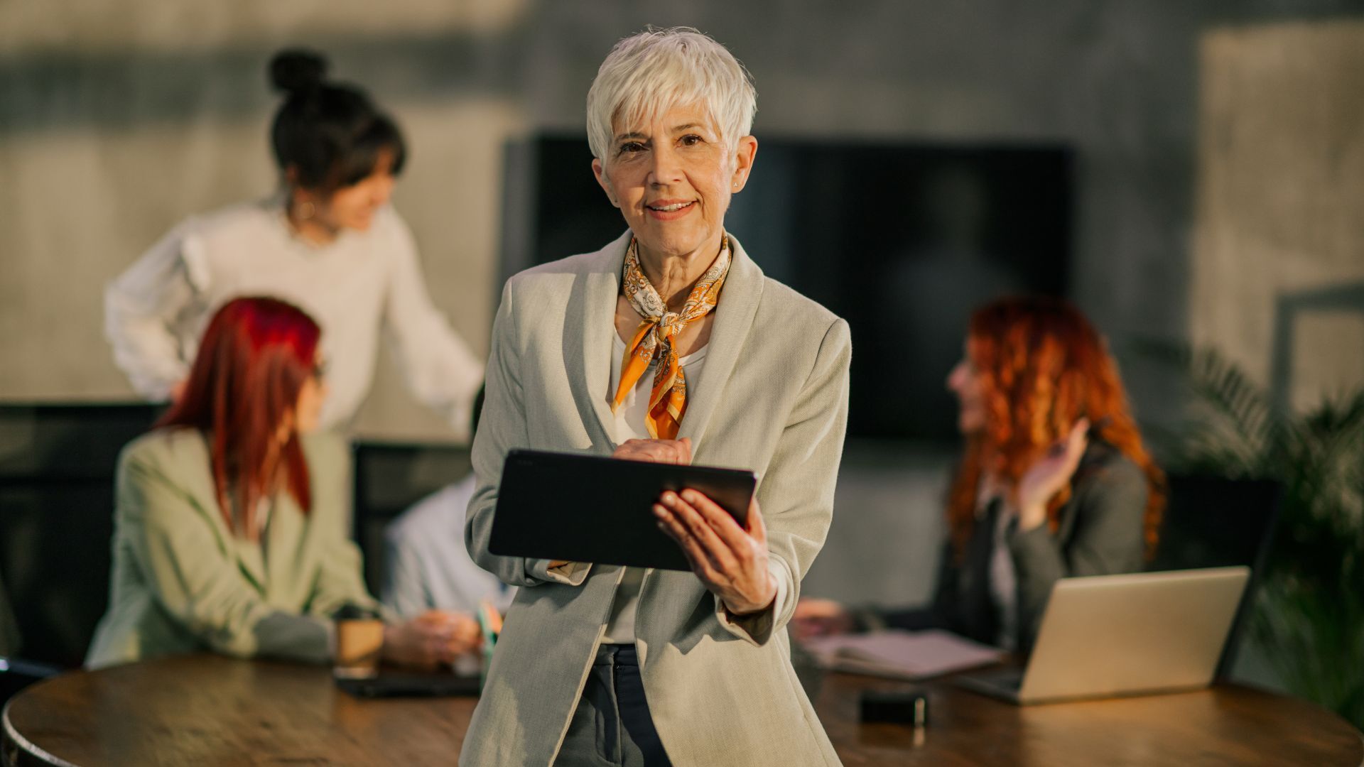 businesswoman-at-boardroom-scrolling-on-tablet_1920x1080