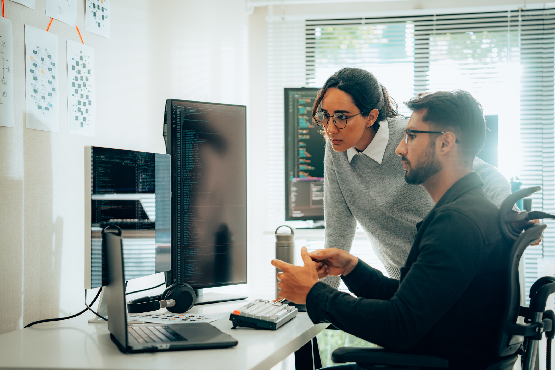 Programmers Collaborating on Software Development in a Modern Office Setting iStock-2050780380