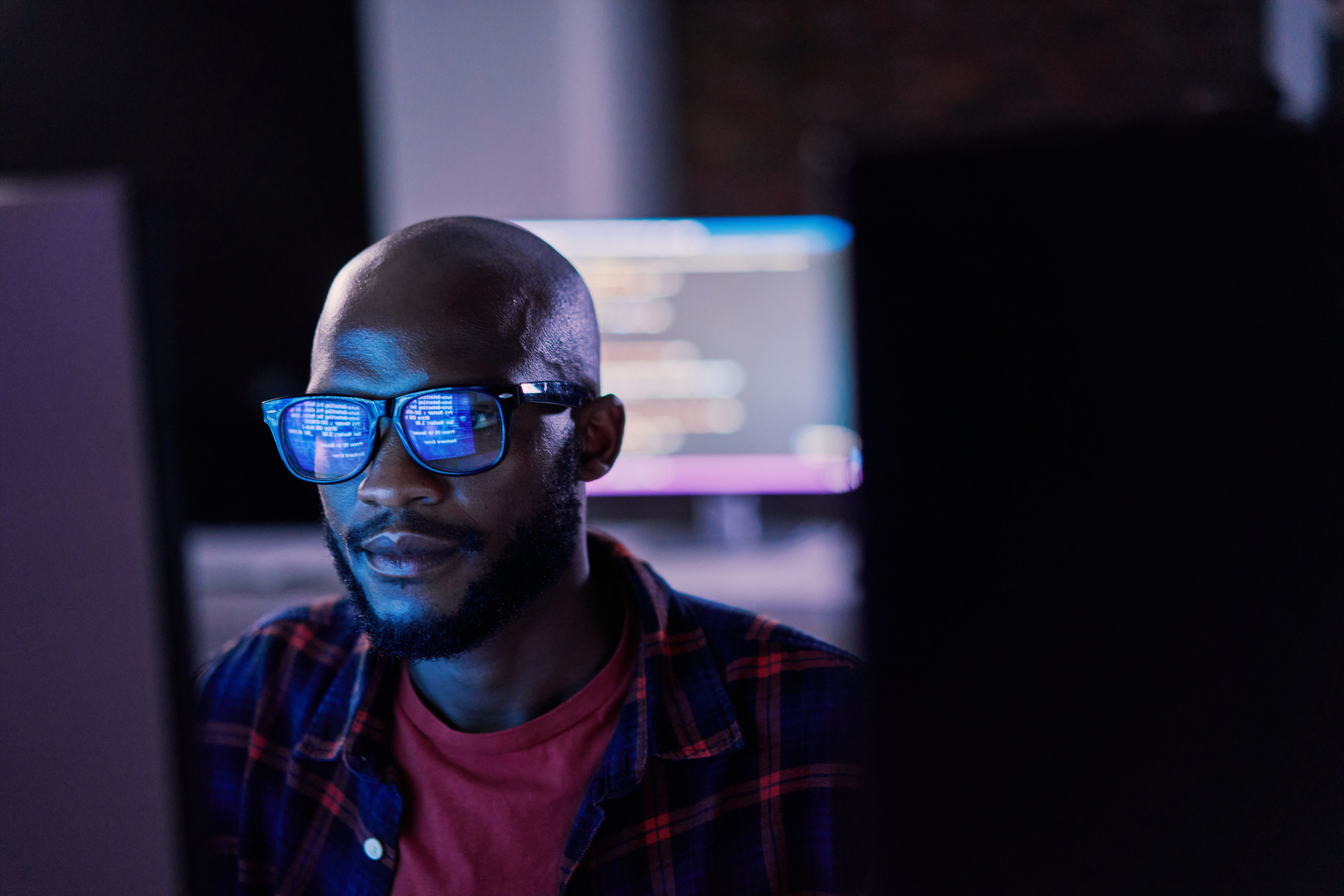 programmer or IT specialist with glasses, focus and cloud computing iStock-2012746941