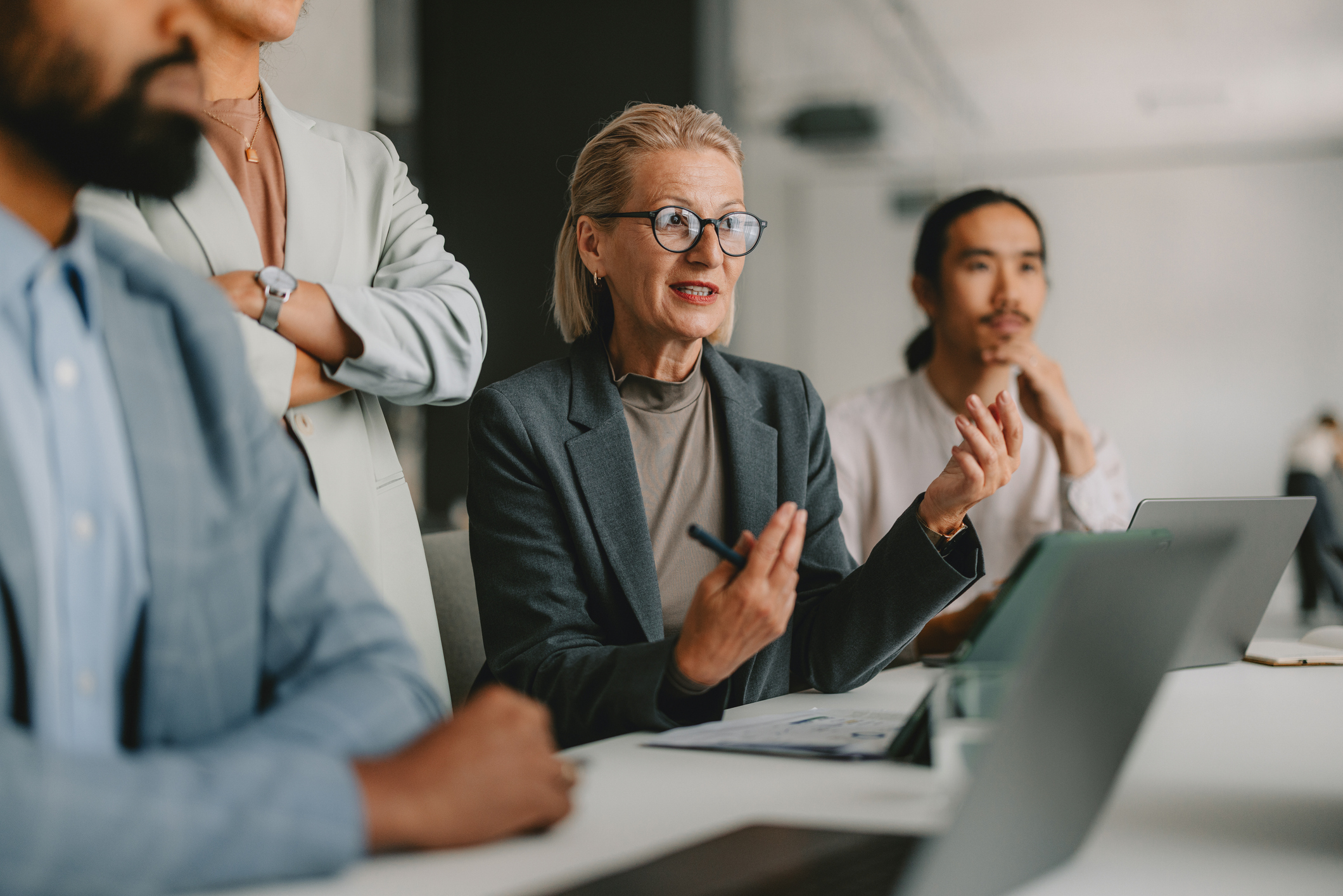Dame bei einem Geschäftstreffen im Bright OfficeiStock-2162033606